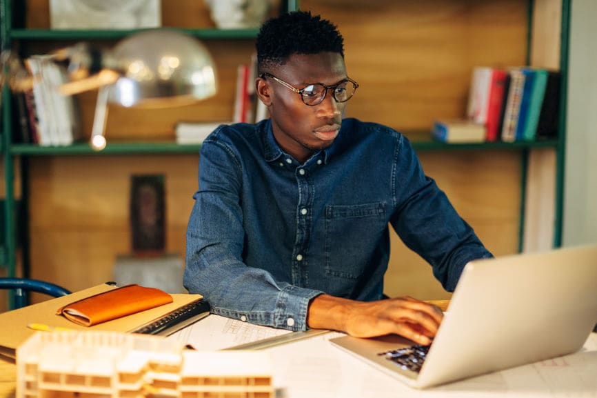 Young Man Working on a Computer Project