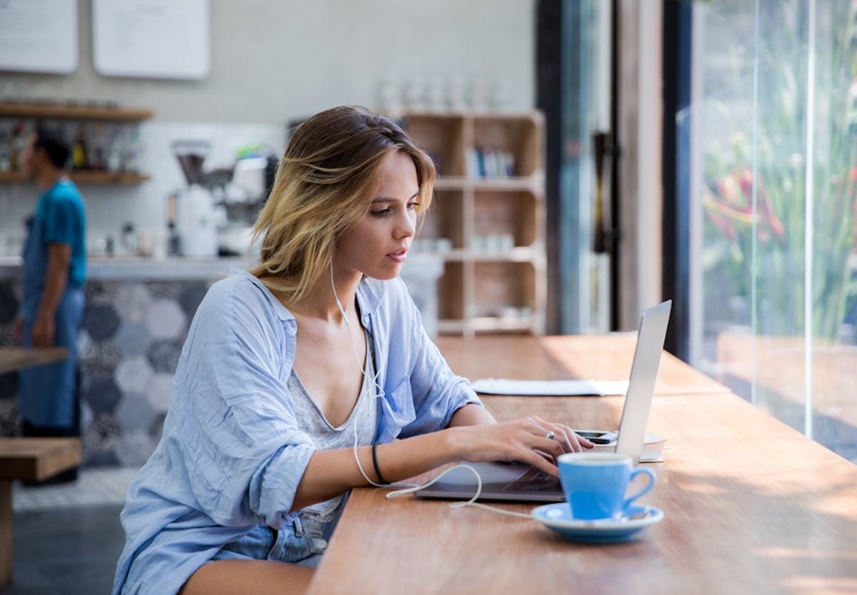Person working on a laptop in a cafe